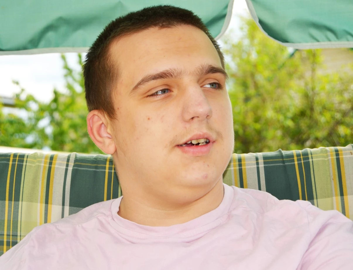 Disabled man with Autism looking past camera