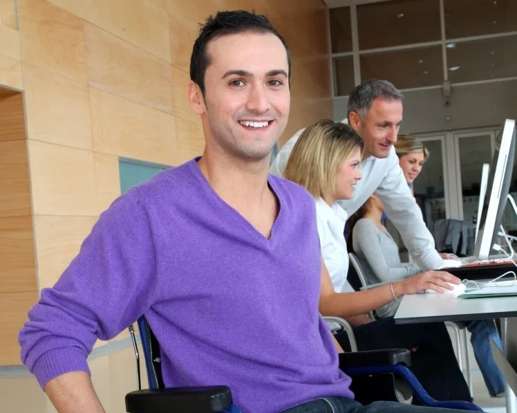 Disabled man in wheelchair smiling at camera